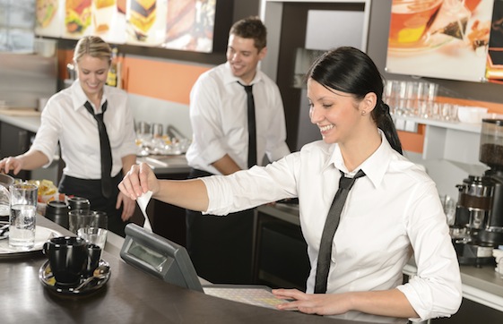 Female cashier giving receipt working in cafe